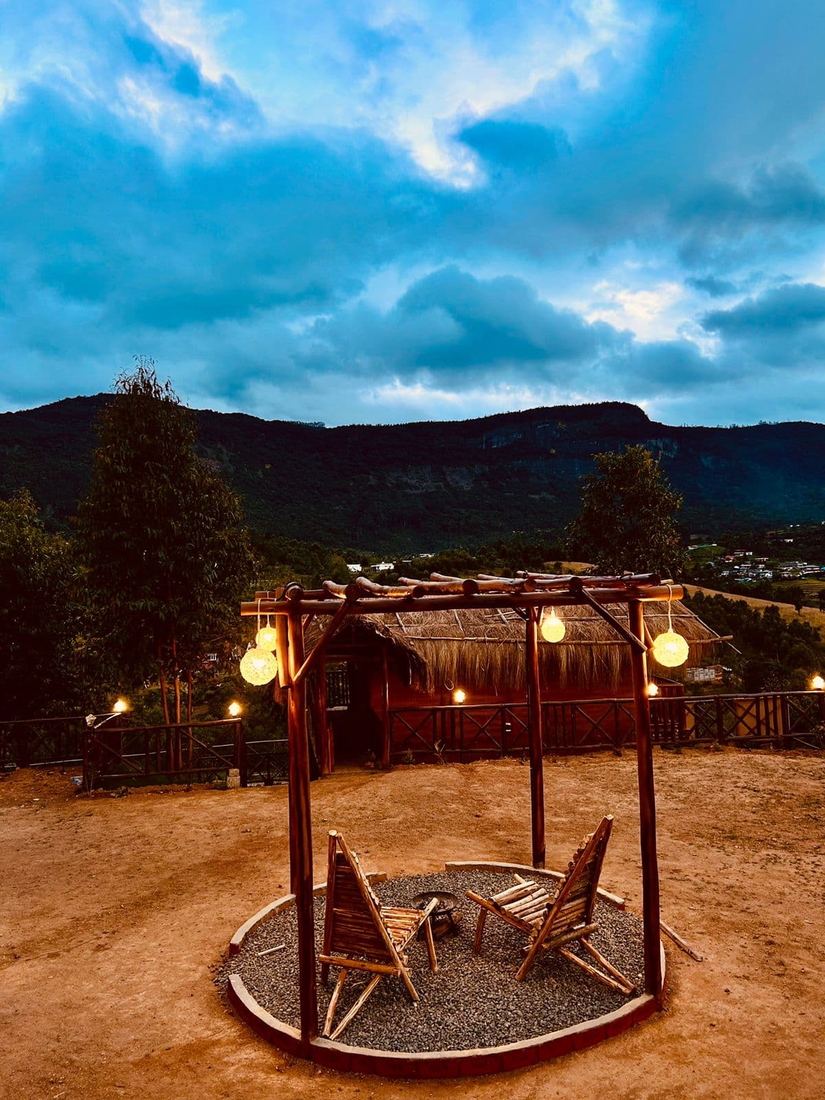 The pergola fire pit at dusk, with the mountain behind