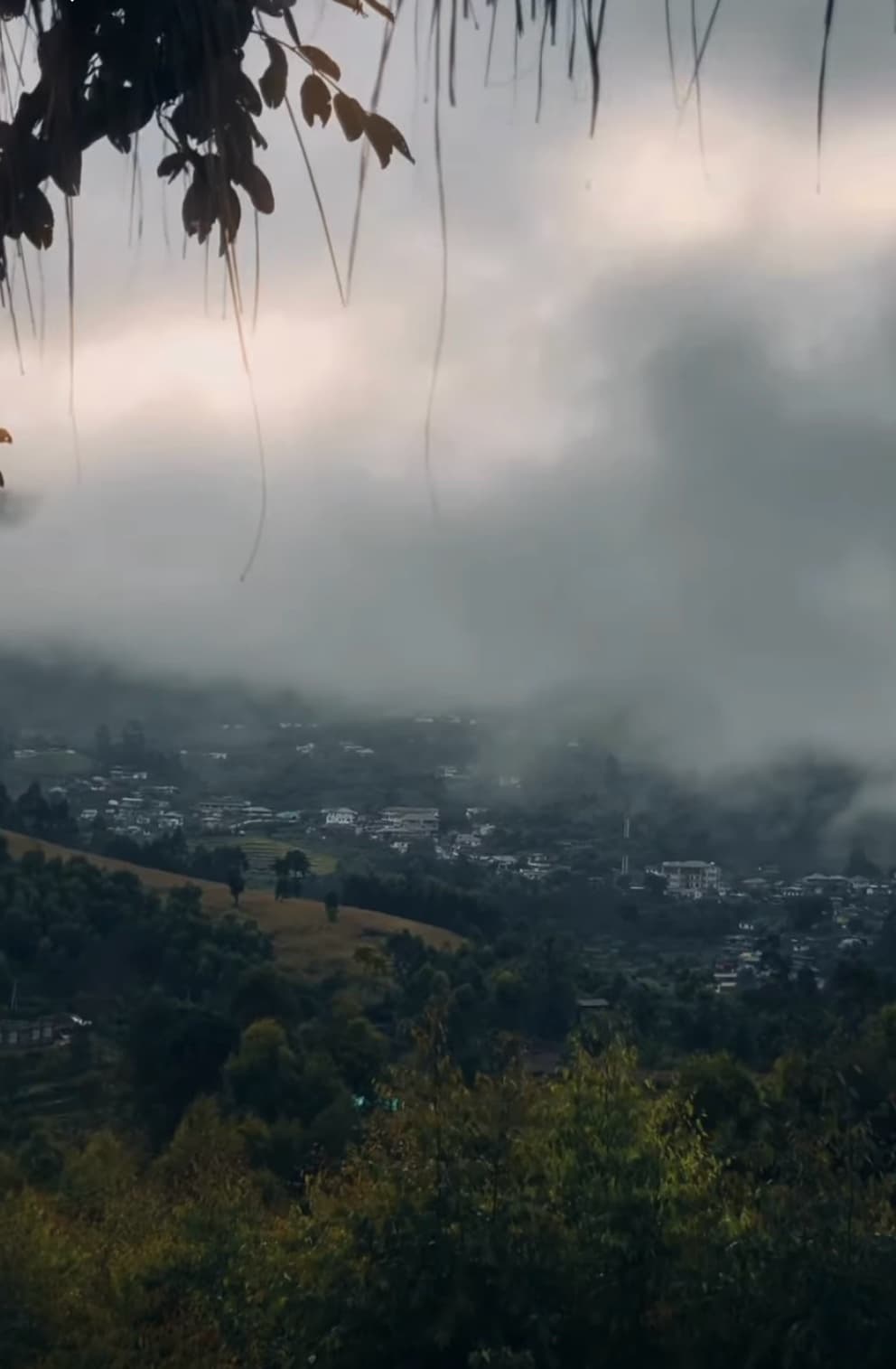 Clouds rolling low over a green valley